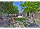 Expansive backyard featuring a well-maintained lawn, mature trees, and a screened-in patio at 8916 Southbay Dr, Tampa, FL 33615