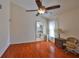 A bedroom that features wood flooring, a ceiling fan, and a peek into another room at 8916 Southbay Dr, Tampa, FL 33615