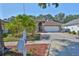 Charming single-Gathering home boasts a well-manicured lawn, mature landscaping, and a two-car garage at 8916 Southbay Dr, Tampa, FL 33615