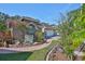 Landscaped front yard with brick-paved walkway, flowerbeds, and mature trees leading to the house at 8916 Southbay Dr, Tampa, FL 33615