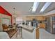 Open concept kitchen area with an island, stainless steel appliances, and skylights at 8916 Southbay Dr, Tampa, FL 33615