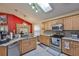 Bright kitchen with skylights, stainless appliances, and red accent wall at 8916 Southbay Dr, Tampa, FL 33615