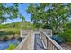 A wooden observation deck overlooking a lush wetland area with dense vegetation and calm waters at 8916 Southbay Dr, Tampa, FL 33615