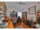 A home office offers multiple desk spaces, shelving and natural light, perfect for working or studying at 8916 Southbay Dr, Tampa, FL 33615