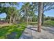 Green park with a gravel path, benches, and various trees, providing a serene outdoor space at 8916 Southbay Dr, Tampa, FL 33615