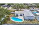 Beautiful home from above, highlighting the refreshing pool, patio, and well-maintained backyard at 10006 N Connechusett Rd, Tampa, FL 33617