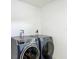 Laundry room featuring new front-load washer and dryer with white walls at 10006 N Connechusett Rd, Tampa, FL 33617