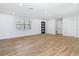 Spacious living room featuring new vinyl flooring, recessed lighting, and a modern front door at 10006 N Connechusett Rd, Tampa, FL 33617