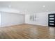 Bright living room featuring new vinyl flooring, recessed lighting, a large window and a modern front door at 10006 N Connechusett Rd, Tampa, FL 33617