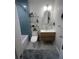 Modern bathroom with blue tile shower, floating vanity, and elegant fixtures at 1003 W Indiana Ave, Tampa, FL 33603
