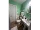 Fresh bathroom with green walls, white fixtures, and a clean, well-lit space at 1003 W Indiana Ave, Tampa, FL 33603