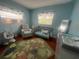 Charming Bedroom with a crib, comfy chair, changing table, and sweet dinosaur-themed decor at 1003 W Indiana Ave, Tampa, FL 33603
