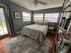 Cozy bedroom featuring a comfortable bed, stylish rug, and access to an outdoor area at 1003 W Indiana Ave, Tampa, FL 33603