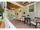 Inviting front porch with swing, seating, and classic brick flooring at 1003 W Indiana Ave, Tampa, FL 33603