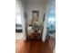 Hallway with hardwood floors, a decorative cabinet, and a glimpse into the living spaces at 1003 W Indiana Ave, Tampa, FL 33603