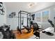 Well-equipped home gym with weights, squat rack, and cardio machine, set against light blue walls at 1003 W Indiana Ave, Tampa, FL 33603