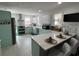 Stylish kitchen with white and aqua cabinets, stainless steel appliances, and a large island with seating at 1003 W Indiana Ave, Tampa, FL 33603