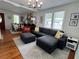 Inviting living room featuring hardwood floors, a comfortable sectional sofa, and a stone fireplace at 1003 W Indiana Ave, Tampa, FL 33603