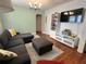 Cozy living room with hardwood floors, a modern light fixture, and a large sectional sofa at 1003 W Indiana Ave, Tampa, FL 33603