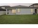 Well-maintained backyard featuring a cozy patio and lush green lawn at 10111 Tuscan Sun Ave, Riverview, FL 33578