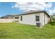 Well-maintained backyard features lush green lawn, patio, and newly painted exterior at 10111 Tuscan Sun Ave, Riverview, FL 33578