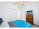 This bedroom features a bed, closet, ceiling fan and dresser at 10111 Tuscan Sun Ave, Riverview, FL 33578