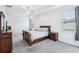 Spacious bedroom with tray ceiling and large windows for ample natural light, plus stylish wood furniture at 10111 Tuscan Sun Ave, Riverview, FL 33578