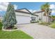 Well-kept one-story home with a two-car garage and manicured landscaping at 10111 Tuscan Sun Ave, Riverview, FL 33578