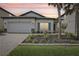 Beautiful one story home with an attached garage, meticulously landscaped front yard, and neutral exterior paint at 10111 Tuscan Sun Ave, Riverview, FL 33578