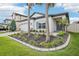 Inviting one-story home with well-maintained landscaping, including palm trees and a paver driveway at 10111 Tuscan Sun Ave, Riverview, FL 33578