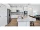 Bright kitchen with stainless steel appliances, center island and modern backsplash at 10111 Tuscan Sun Ave, Riverview, FL 33578