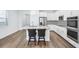 Modern eat-in kitchen with stainless steel appliances and center island with barstool seating at 10111 Tuscan Sun Ave, Riverview, FL 33578