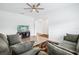 Bright living room with ceiling fan, hardwood floors and comfortable seating at 10111 Tuscan Sun Ave, Riverview, FL 33578