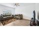 Comfortable living room with neutral colors, hardwood floors, and a large television at 10111 Tuscan Sun Ave, Riverview, FL 33578