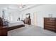 Spacious main bedroom features tray ceiling, large windows, carpet floors, and handsome dark-wood furniture at 10111 Tuscan Sun Ave, Riverview, FL 33578