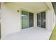 Covered patio featuring sliding glass doors and stucco exterior, perfect for outdoor relaxation and entertaining at 10111 Tuscan Sun Ave, Riverview, FL 33578