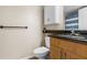 Bathroom featuring wood vanity cabinet, granite counters, and commode at 10511 Waterview Ct # 10511, Tampa, FL 33615