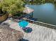A dock featuring patio furniture with umbrellas, lounge chairs, and a tiki hut at 10511 Waterview Ct # 10511, Tampa, FL 33615