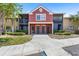Inviting condo building with colorful facade, screened balconies, and neatly landscaped grounds at 10511 Waterview Ct # 10511, Tampa, FL 33615