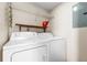 Laundry room with washer, dryer, overhead rack, and wood shelf at 10511 Waterview Ct # 10511, Tampa, FL 33615