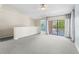 Open-concept living room with vaulted ceiling and sliding glass door to balcony at 10511 Waterview Ct # 10511, Tampa, FL 33615