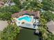 Aerial view featuring a pool, and a lake, complete with lounge chairs and tiki huts at 10511 Waterview Ct # 10511, Tampa, FL 33615