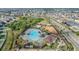 An aerial view showcases a large community pool, playground, and surrounding homes and neighborhood amenities at 11684 Brighton Knoll Loop, Riverview, FL 33579