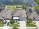 Aerial view showcasing a well-maintained home with a private backyard and serene lake view at 11684 Brighton Knoll Loop, Riverview, FL 33579