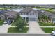 Beautiful home with manicured lawn, complementing the serene lake and neighborhood setting at 11684 Brighton Knoll Loop, Riverview, FL 33579