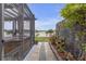 Scenic backyard view with a hot tub, screened enclosure, and decorative plants at 11684 Brighton Knoll Loop, Riverview, FL 33579