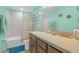 Bright bathroom with a bathtub and vanity, decorated in light aqua colors and nautical accents at 11684 Brighton Knoll Loop, Riverview, FL 33579