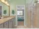 A full bathroom featuring granite countertops, walk-in shower, and entry to the bedroom at 11684 Brighton Knoll Loop, Riverview, FL 33579