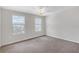 Bright bedroom featuring two windows, a ceiling fan, and neutral walls at 11684 Brighton Knoll Loop, Riverview, FL 33579