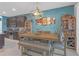 Dining room with a modern table, bench seating, accent lighting and convenient access to the kitchen at 11684 Brighton Knoll Loop, Riverview, FL 33579